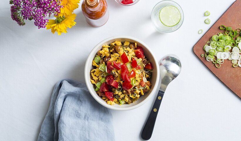 Colorful balanced vegetable bowl with grains, legumes, and fresh produce