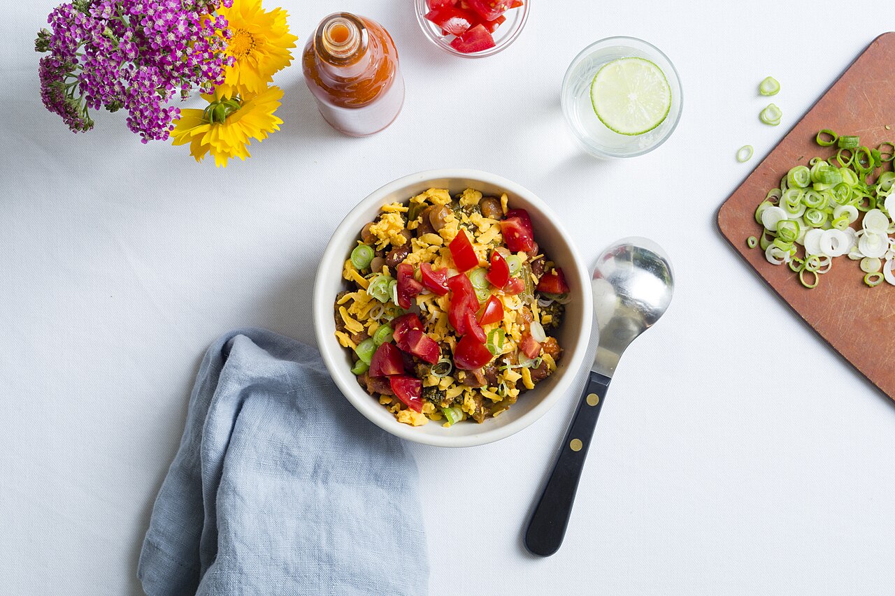 Colorful balanced vegetable bowl with grains, legumes, and fresh produce